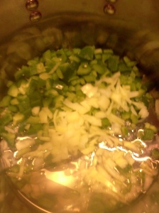 Chopped green bell pepper,  onion, and garlic all sauteing in oil