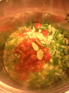 Chopped tomatoes and bay leaves added to pot