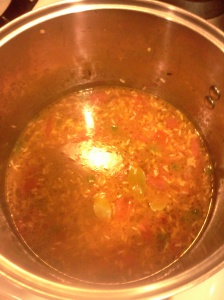 Chicken stock and rice added to pot